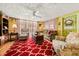 A well-lit living room features a plush sofa and recliner, a patterned rug, and a ceiling fan at 1491 Avenue F Ne, Winter Haven, FL 33881