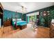Primary bedroom with a four post bed, private outdoor access and a rocking chair at 1491 Avenue F Ne, Winter Haven, FL 33881