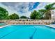 A refreshing pool surrounded by a uniquely decorated fence and lush greenery, creating a private oasis at 1491 Avenue F Ne, Winter Haven, FL 33881