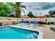 Sparkling pool surrounded by lounge chairs and umbrellas provides the perfect outdoor oasis for relaxation at 1491 Avenue F Ne, Winter Haven, FL 33881