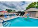 A refreshing backyard pool with a fun inflatable toy, patio furniture, and a peaceful garden setting at 1491 Avenue F Ne, Winter Haven, FL 33881