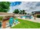 Backyard showcasing a refreshing pool, colorful decor, and ample seating for outdoor relaxation at 1491 Avenue F Ne, Winter Haven, FL 33881