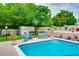 Backyard pool surrounded by colorful decorations, manicured landscaping, and comfortable seating areas for relaxation at 1491 Avenue F Ne, Winter Haven, FL 33881