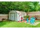 View of a well-kept storage shed decorated with flowers, providing practical backyard storage at 1491 Avenue F Ne, Winter Haven, FL 33881