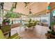 Inviting sunroom with tiled floor, dining table, and ceiling fan, with a view of the sparkling outdoor pool at 1491 Avenue F Ne, Winter Haven, FL 33881