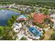 Aerial photo of a community with a pool, lake, playground, and clubhouse, offering a resort-style living experience at 151 Hideaway Beach Ln, Kissimmee, FL 34746