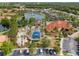 Overhead shot showcasing a community pool, clubhouse, playground, basketball court, and adjacent parking area at 151 Hideaway Beach Ln, Kissimmee, FL 34746