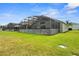 Expansive backyard with a screened-in pool area, offering privacy and outdoor enjoyment at 151 Hideaway Beach Ln, Kissimmee, FL 34746