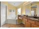 Bright bathroom with a tub, vanity with countertop, and walk-in shower at 151 Hideaway Beach Ln, Kissimmee, FL 34746