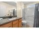Bathroom with a granite vanity, a mirror, and a shower-tub combination with tile surround at 151 Hideaway Beach Ln, Kissimmee, FL 34746