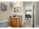Well-lit bathroom with a vanity, toilet, and doorway to dining room at 151 Hideaway Beach Ln, Kissimmee, FL 34746