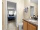 Bathroom with granite vanity and a view into an adjacent bedroom with twin beds at 151 Hideaway Beach Ln, Kissimmee, FL 34746