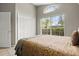 Bright bedroom featuring a queen-size bed, a large window, and white trim at 151 Hideaway Beach Ln, Kissimmee, FL 34746