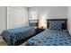 Bedroom featuring two twin beds with blue and white patterned bedding and a large closet at 151 Hideaway Beach Ln, Kissimmee, FL 34746