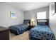 Neutral bedroom featuring twin beds with blue patterned bedding at 151 Hideaway Beach Ln, Kissimmee, FL 34746