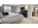 Neutral bedroom featuring a queen-size bed, a dresser with television, and a view of the pool at 151 Hideaway Beach Ln, Kissimmee, FL 34746
