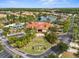 Aerial view of the clubhouse with a pool, amenities, and lush landscaping in the community at 151 Hideaway Beach Ln, Kissimmee, FL 34746