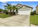Charming single-Gathering home with well-maintained lawn and landscaping with lovely palm trees at 151 Hideaway Beach Ln, Kissimmee, FL 34746
