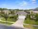 Landscaped one-story home features a two-car garage, neutral paint, and a well-manicured lawn at 151 Hideaway Beach Ln, Kissimmee, FL 34746