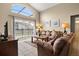 Inviting living room with high ceilings and access to a screened-in pool at 151 Hideaway Beach Ln, Kissimmee, FL 34746