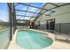 Screened pool featuring clear blue water, steps for easy access, and lounge chairs for relaxation at 151 Hideaway Beach Ln, Kissimmee, FL 34746