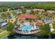 Aerial view of a large community pool and recreation center surrounded by palm trees and lush landscaping at 151 Hideaway Beach Ln, Kissimmee, FL 34746