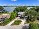 Aerial view of a home featuring a red front door and modern landscaping near a serene lake at 1540 N Lake Mirror Nw Dr, Winter Haven, FL 33881