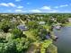 Lakefront home with solar panels and private dock on calm waters, surrounded by lush greenery and serene views at 1540 N Lake Mirror Nw Dr, Winter Haven, FL 33881