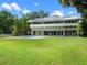 Modern two-story home features a backyard pool, well-manicured lawn, solar panels and several sliding glass doors at 1540 N Lake Mirror Nw Dr, Winter Haven, FL 33881
