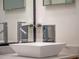 Close up of bathroom sink and faucet, framed square mirror, electrical outlet, and granite countertop at 1540 N Lake Mirror Nw Dr, Winter Haven, FL 33881
