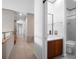 Hallway leading to a bathroom with a white vanity at 1540 N Lake Mirror Nw Dr, Winter Haven, FL 33881