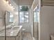 Bathroom featuring a double sink vanity with granite countertops and a glass enclosed shower at 1540 N Lake Mirror Nw Dr, Winter Haven, FL 33881