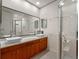 Modern bathroom with double sinks, sleek fixtures, and a glass-enclosed shower at 1540 N Lake Mirror Nw Dr, Winter Haven, FL 33881