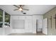 Bright bedroom with built-in storage cabinets, drawers and shelves and a large window with outdoor views at 1540 N Lake Mirror Nw Dr, Winter Haven, FL 33881