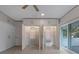 Bedroom boasts large built in storage, and a sliding door to balcony, the open closet allows a view of shelving at 1540 N Lake Mirror Nw Dr, Winter Haven, FL 33881