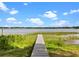 Wooden dock on the water offers serene lake views and direct access for boating or enjoying waterfront activities at 1540 N Lake Mirror Nw Dr, Winter Haven, FL 33881