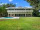 Back of house showing a pool with views of the yard at 1540 N Lake Mirror Nw Dr, Winter Haven, FL 33881