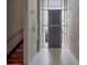 Bright foyer features gray tile flooring, block walls, and an eye-catching staircase at 1540 N Lake Mirror Nw Dr, Winter Haven, FL 33881