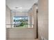 Hallway with concrete block walls and large picture window looking out on the front yard at 1540 N Lake Mirror Nw Dr, Winter Haven, FL 33881