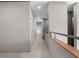 Hallway with concrete block walls and light tile flooring; a modern, minimalist design at 1540 N Lake Mirror Nw Dr, Winter Haven, FL 33881
