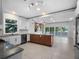 Bright, modern kitchen with stainless steel appliances, white cabinets, and a center island with seating at 1540 N Lake Mirror Nw Dr, Winter Haven, FL 33881