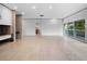 Open living room with fireplace, tiled floors and views to the outdoors at 1540 N Lake Mirror Nw Dr, Winter Haven, FL 33881