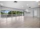 Spacious living area featuring recessed lighting, tile flooring, and wall-to-wall sliding glass doors at 1540 N Lake Mirror Nw Dr, Winter Haven, FL 33881