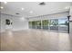 Bright living room with a wall of windows offering scenic outdoor views and natural light at 1540 N Lake Mirror Nw Dr, Winter Haven, FL 33881