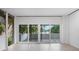 Living room with sliding glass doors to a lakefront view at 1540 N Lake Mirror Nw Dr, Winter Haven, FL 33881