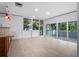 Open living space with a view of lush trees, tile floors, and contemporary lighting at 1540 N Lake Mirror Nw Dr, Winter Haven, FL 33881