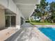 Inviting pool and patio area, with mature trees and landscaping for a tranquil outdoor space at 1540 N Lake Mirror Nw Dr, Winter Haven, FL 33881