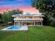 Stunning two-story home featuring a pool, spacious yard, and solar panels for energy efficiency at 1540 N Lake Mirror Nw Dr, Winter Haven, FL 33881