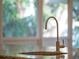 Close up view of a kitchen sink with granite countertop and a scenic window at 1540 N Lake Mirror Nw Dr, Winter Haven, FL 33881