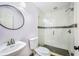 Bathroom with glass shower stall, white tile, and new fixtures at 1553 Wright Dr, Lakeland, FL 33805